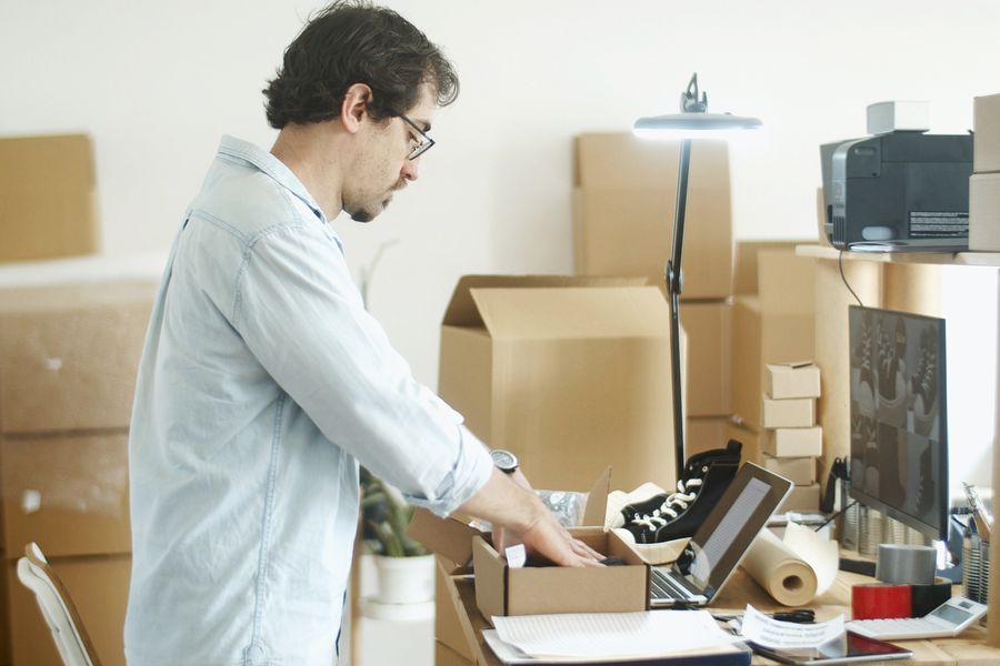 Dono de e-commerce embalando pedidos